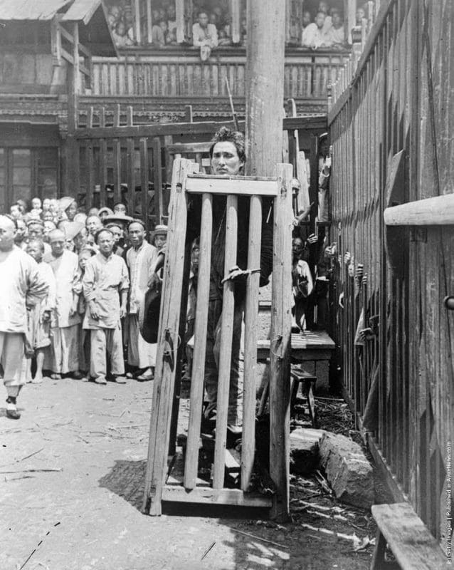 Um pirata que matou pelo menos 6 pessoas aguarda sua execução na China, em 1900. Ele está de pé sorbe pedras e vigas de madeira, que a cada dia foram removidas com sua cabeça presa para fora. A intenção era fazê-lo sofrer antes da morte