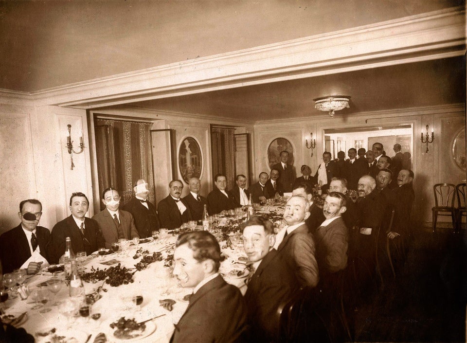 Jantar para soldados franceses com graves lesões faciais recebidos durante a Primeira Guerra Mundial, realizado por Henri Manuel em 1925.